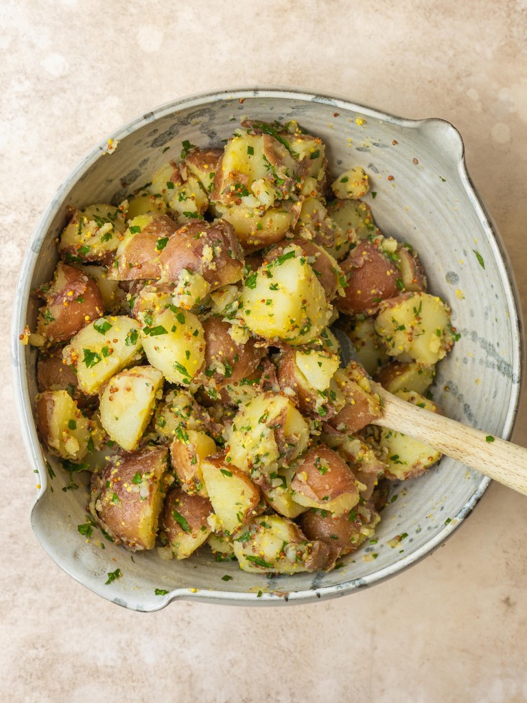 Above view of mustard potato salad in a mixing bowl
