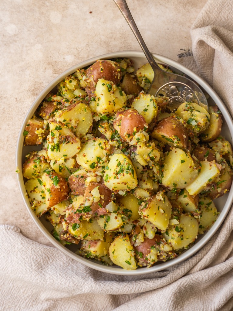 Above view of herbed potato salad in a serving bowl