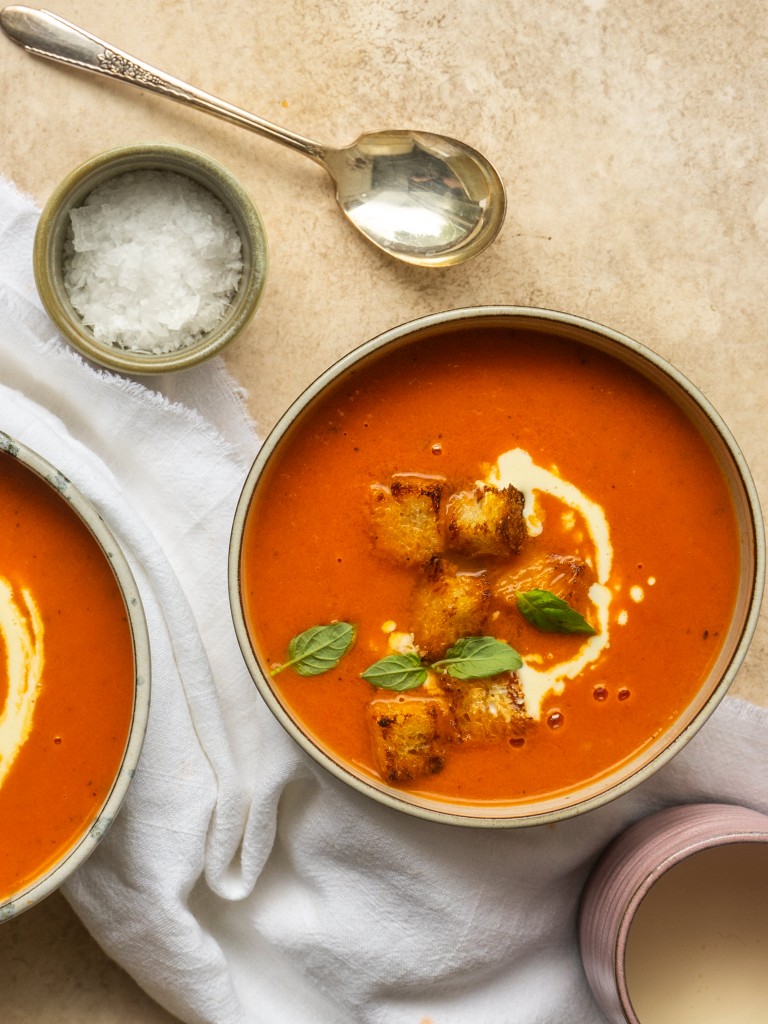 Instant pot tomato soup in a serving bowl with garnishes