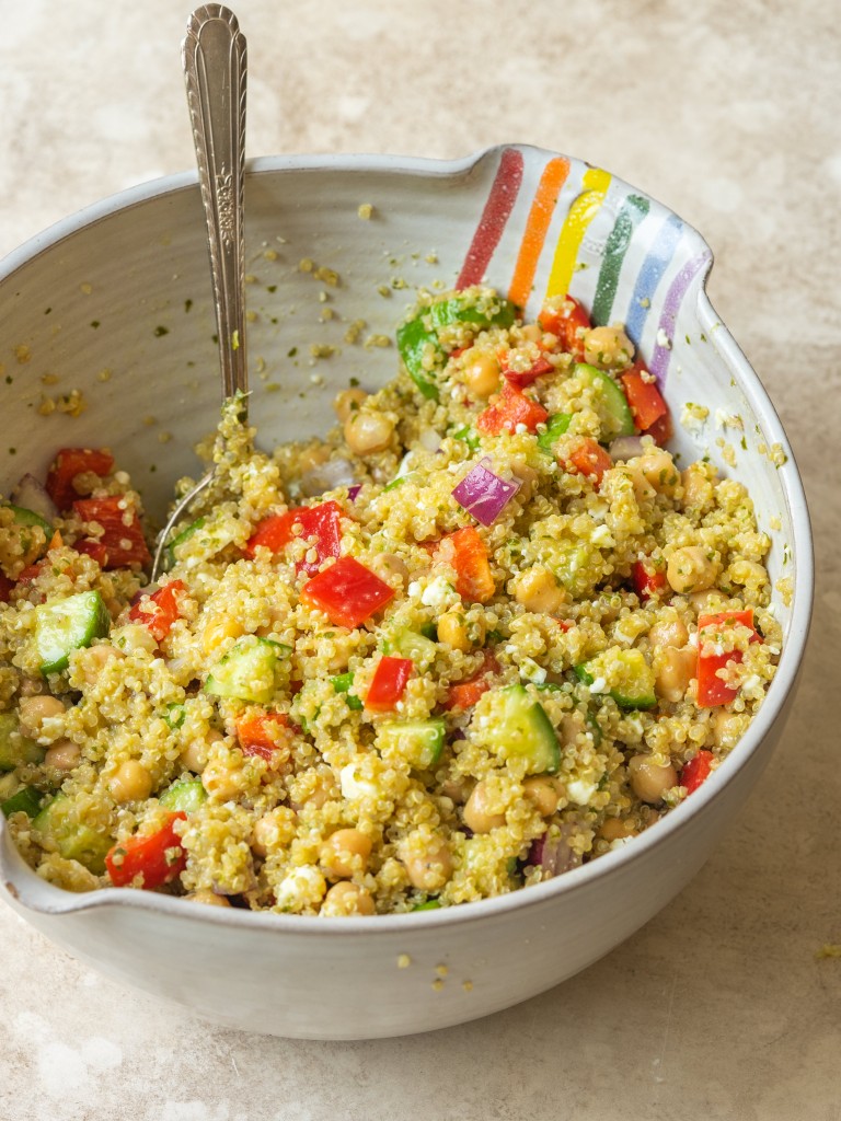 Quinoa chickpea salad with fresh veggies in a mixing bowl