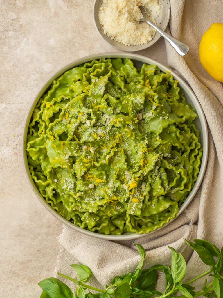 Above view of super green pasta sauce on mafaldine noodles in a serving bowl