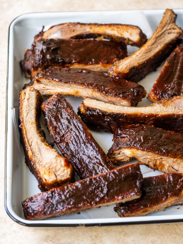 Air fryer ribs cut into pieces with barbecue sauce on top