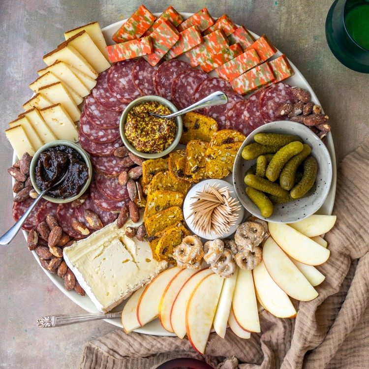 fall charcuterie board with glasses of wine