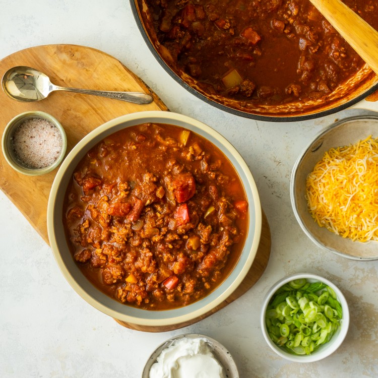 No bean turkey chili recipe in a serving bowl next to topping options