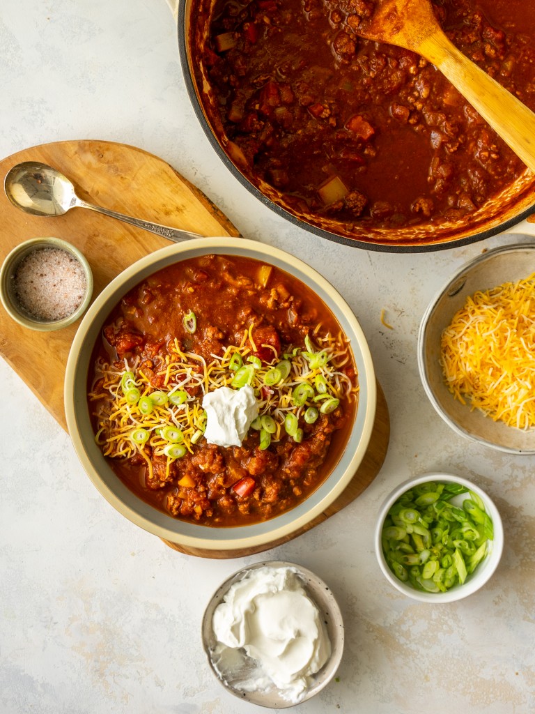 Easy no bean chili recipe topped with green onion, cheese and sour cream