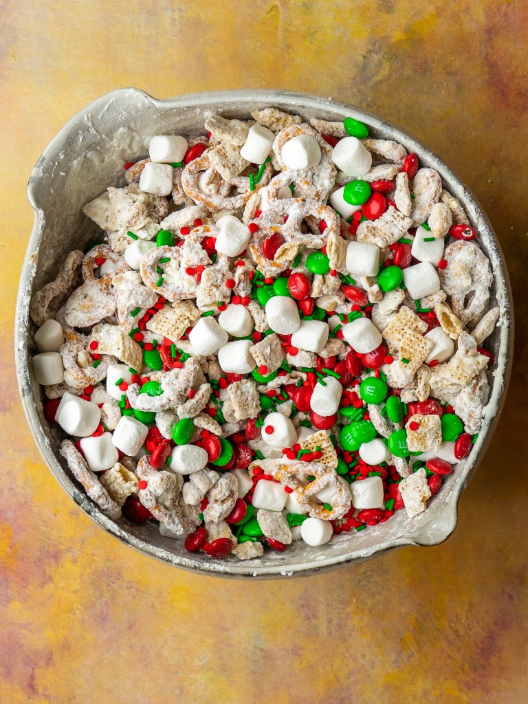 Above view of christmas chex mix recipe in a mixing bowl