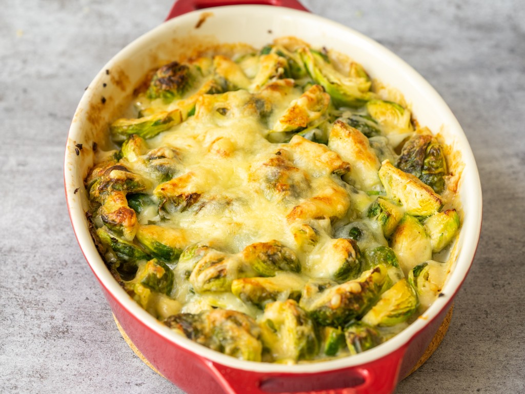 Three quarter view of baked cheesy brussels sprouts