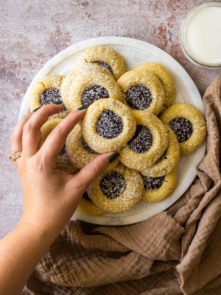Buttery shortbread cookies filled with chocolate ganache and topped with powdered sugar