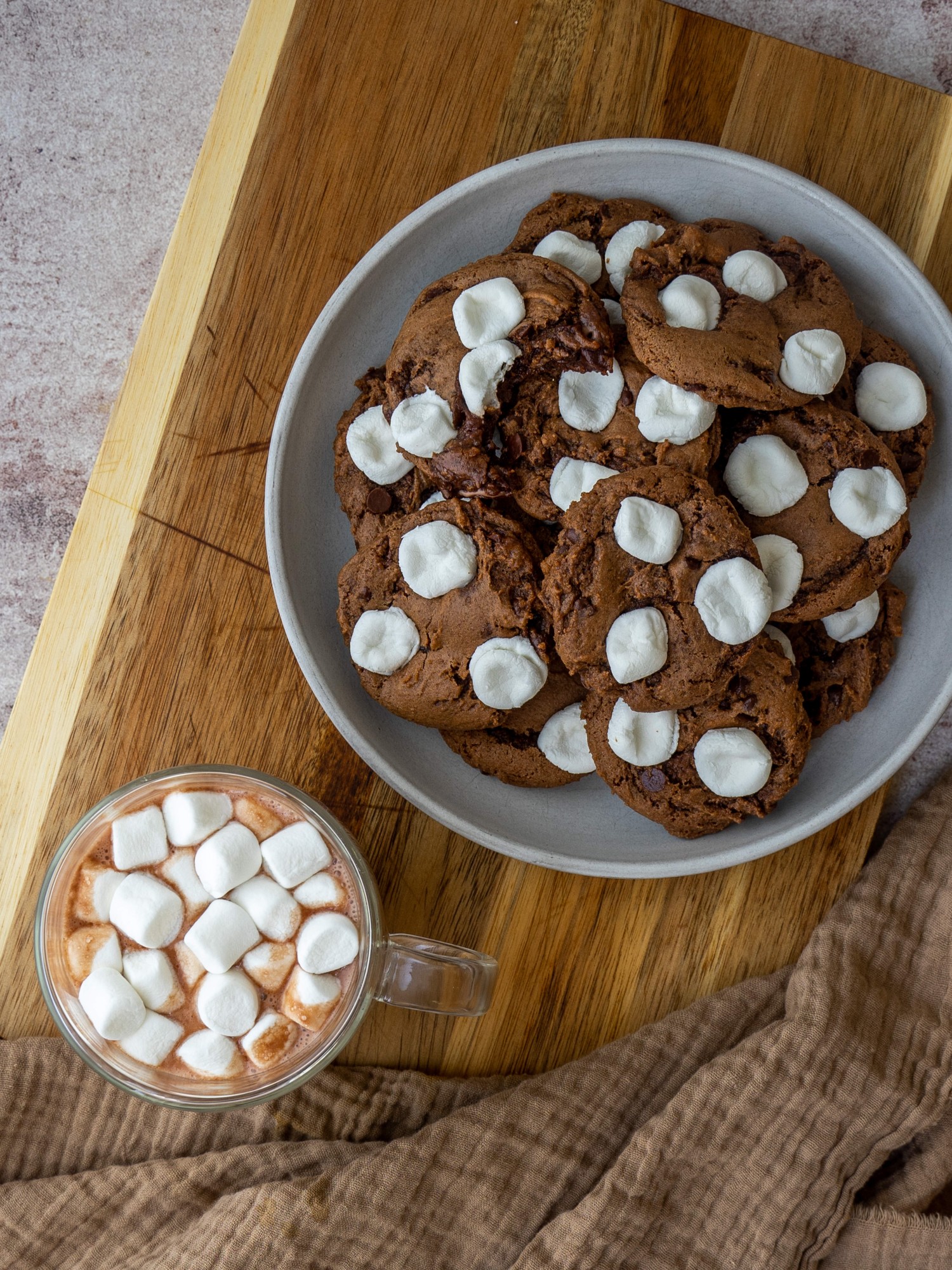 Hot cocoa cookie recipe next to a cup of hot chocolate