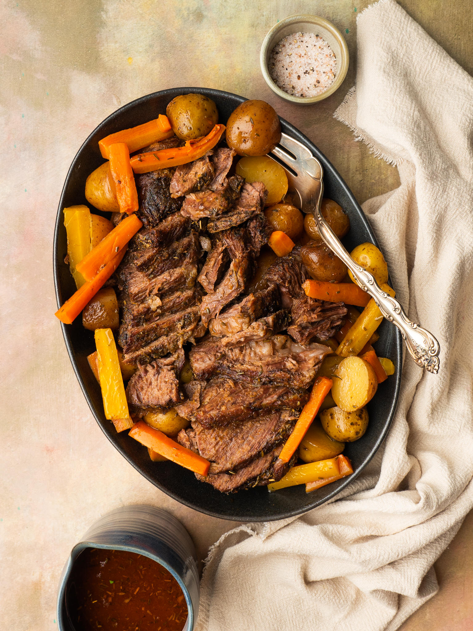 Tender oven baked chuck roast recipe served with au jus