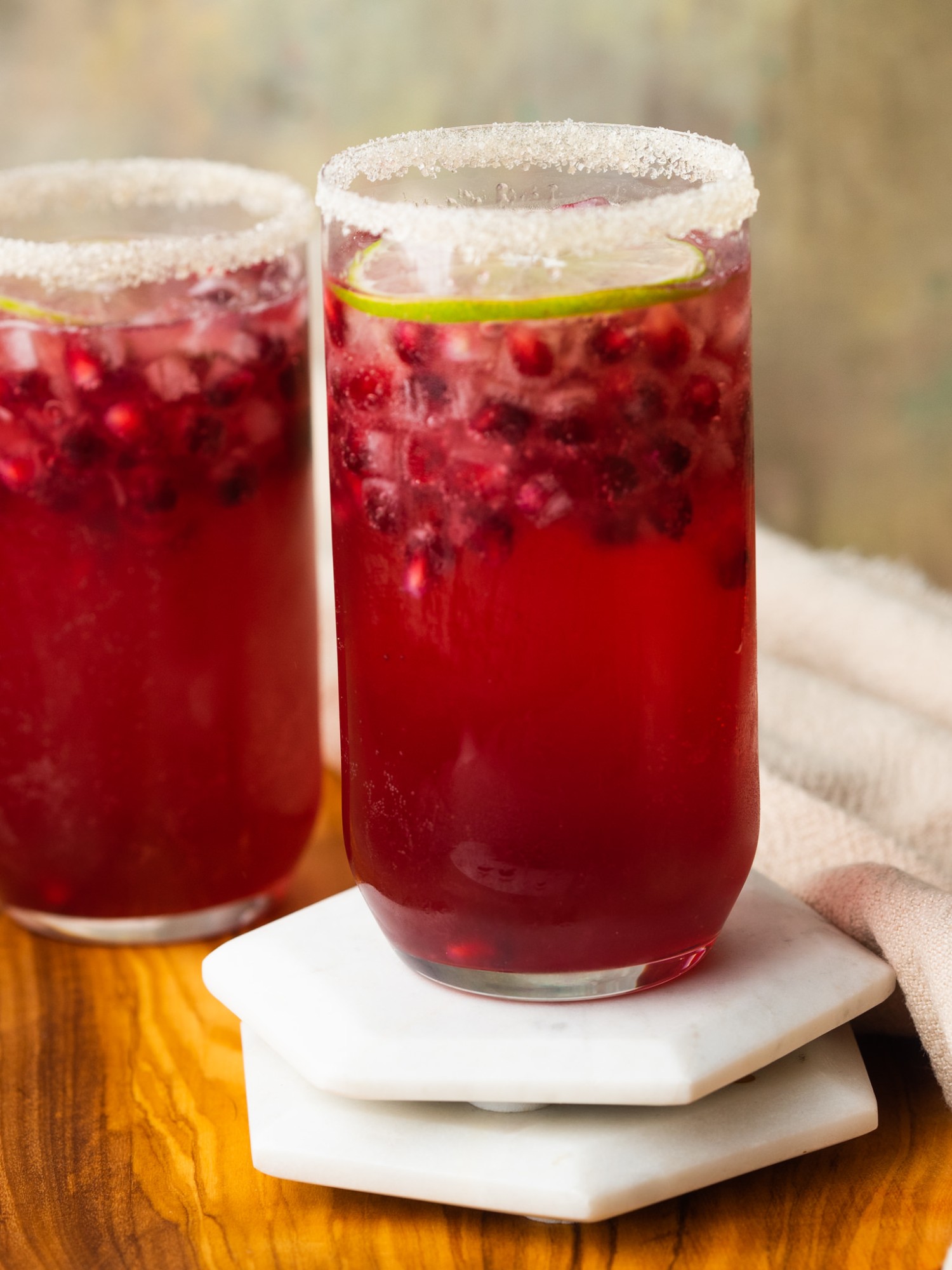 Pomegranate margaritas garnished with sugar and lime