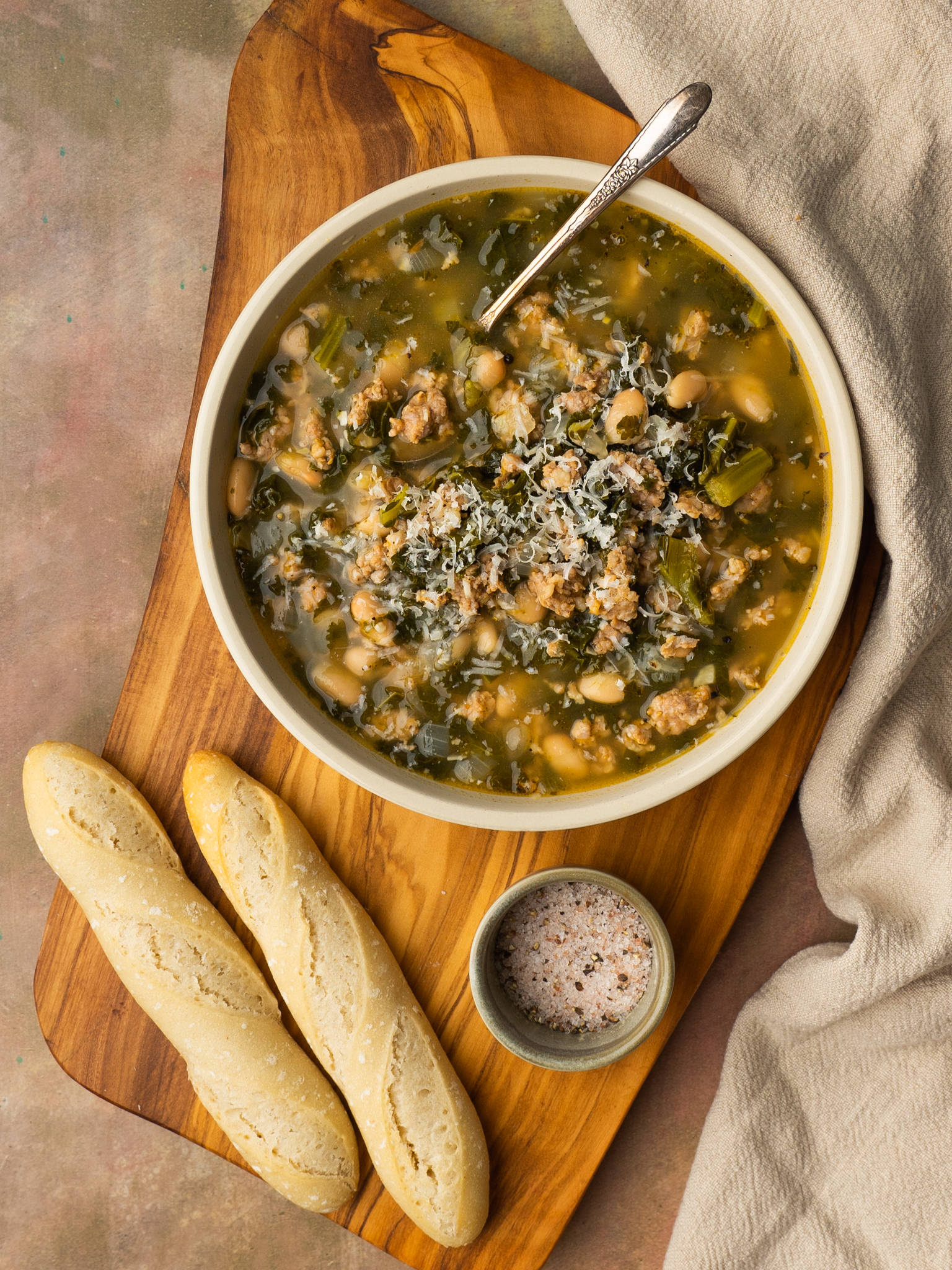 Sausage kale and white bean soup in a serving bowl