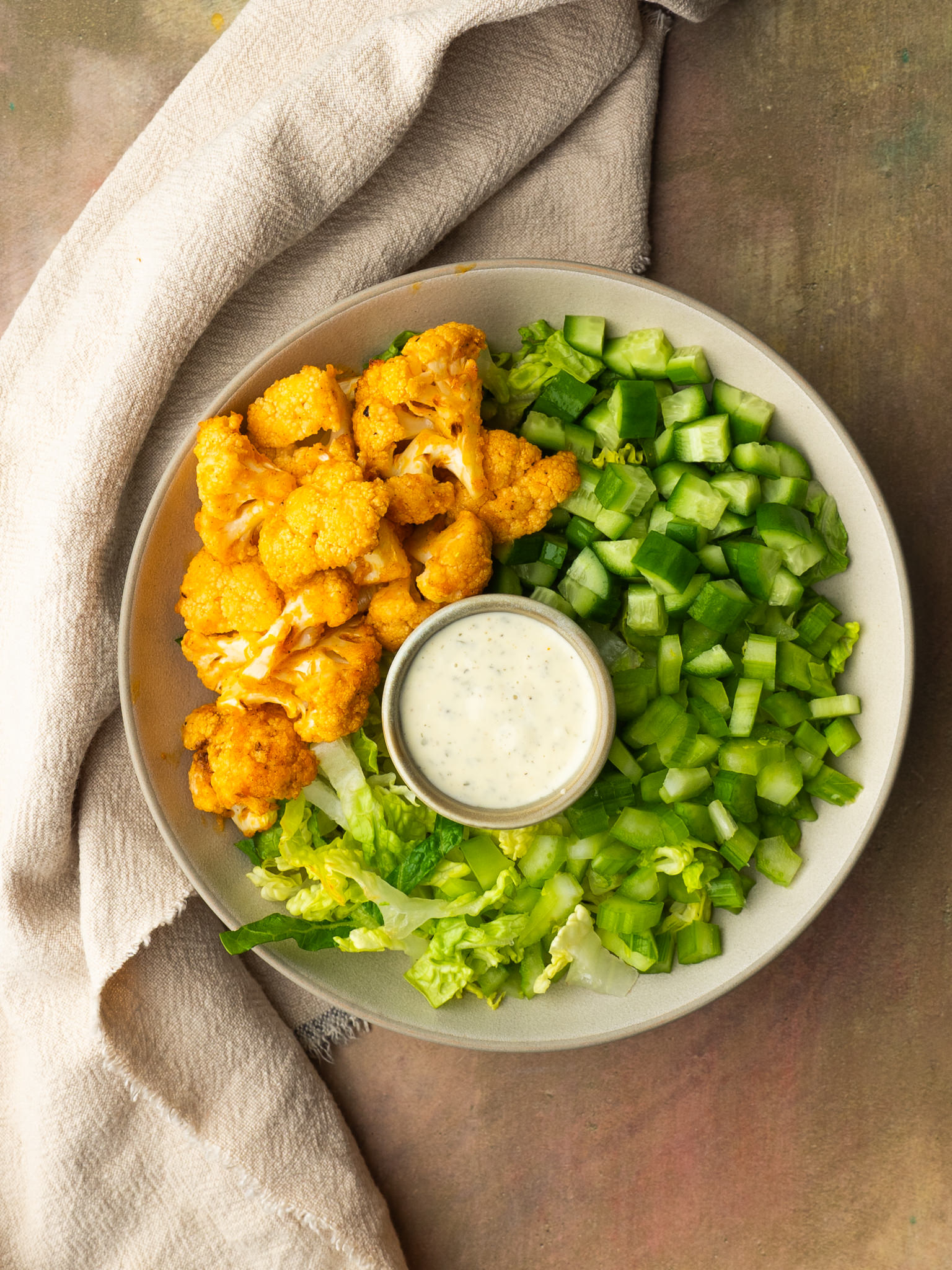 Above view of a salad with buffalo cauliflower made in air fryer