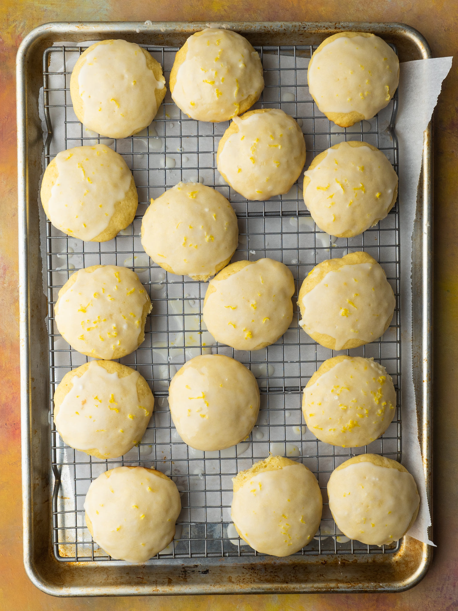 italian lemon ricotta cookies on a wire rack after they were glazed