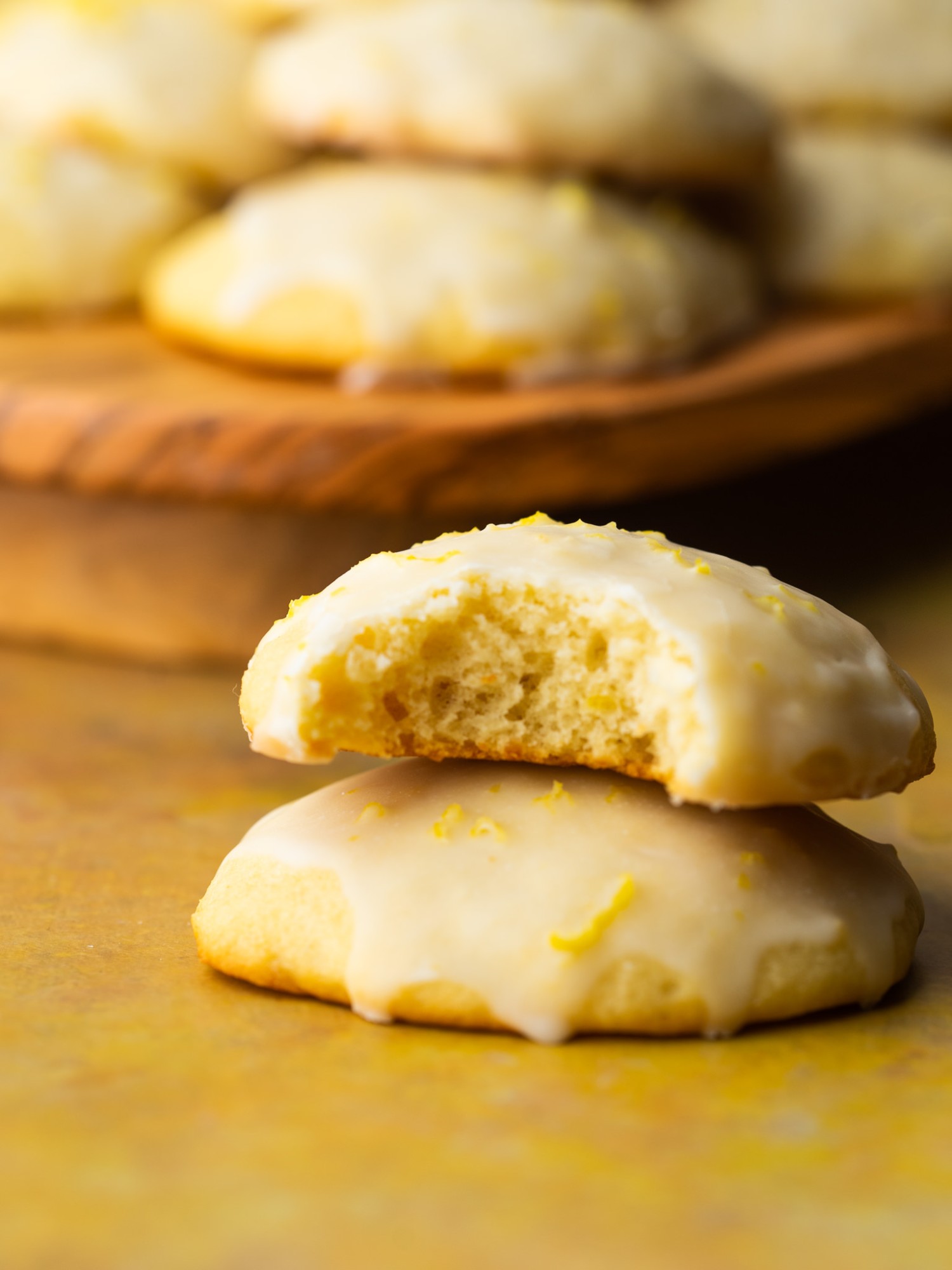 Italian lemon ricotta cookies stacked up with a bite out of one