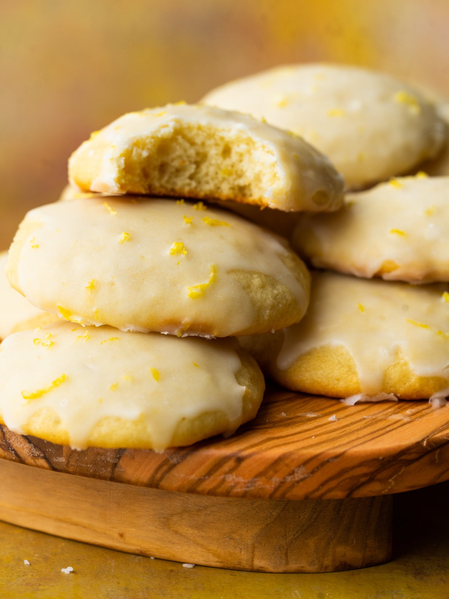 Lemon ricotta cookie recipe with lemon glaze and a bite out of the cookies
