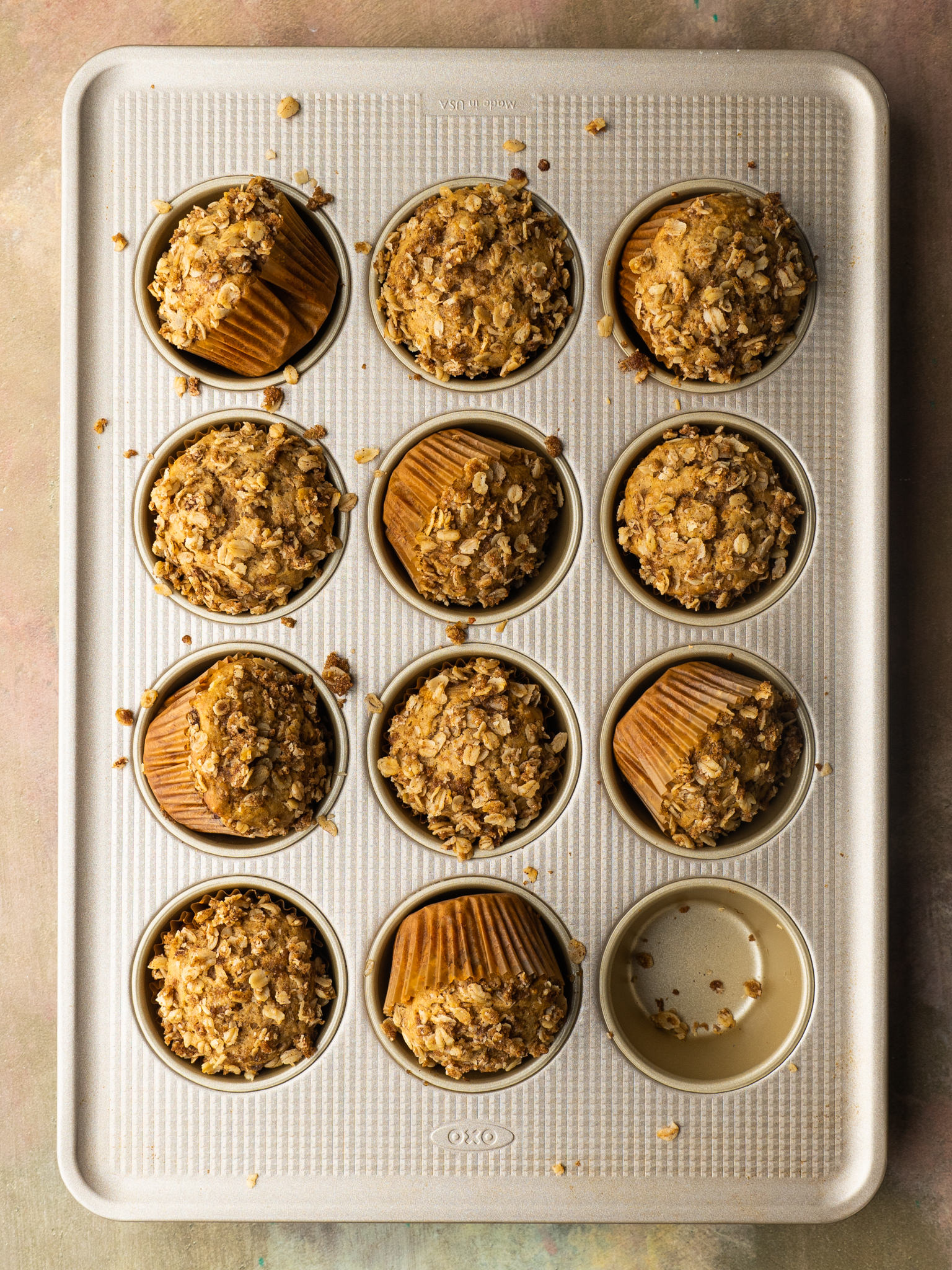 Above view of applesauce oatmeal muffins in a muffin tin
