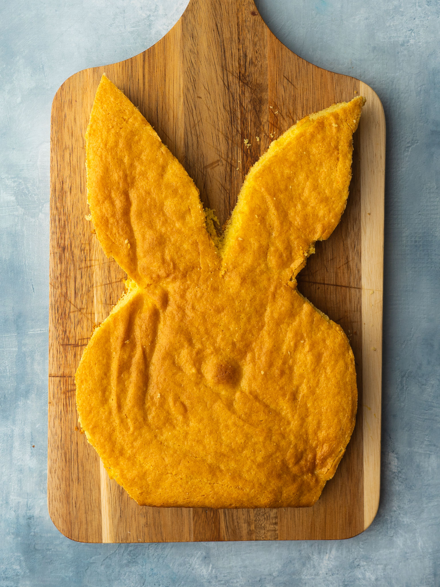 Above view of bunny cake cut out on a cutting board
