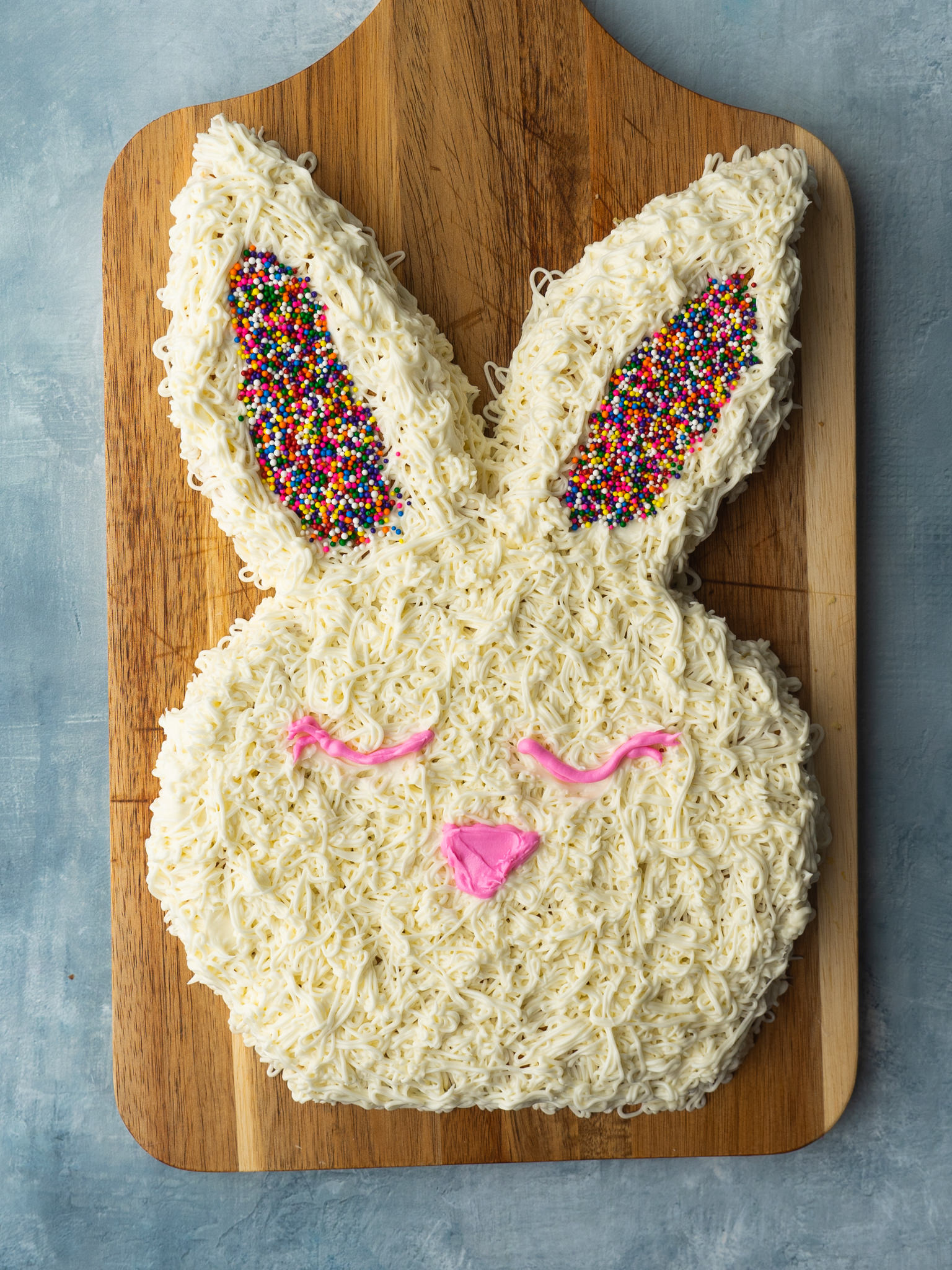 The easiest easter bunny cake decorated and on a cutting board