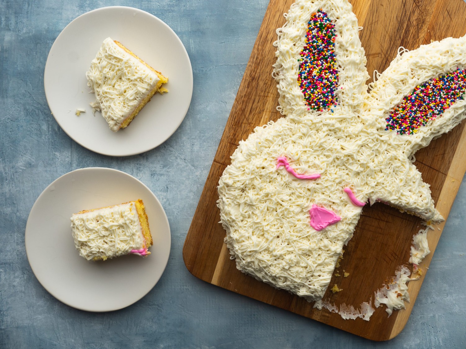 Above view of an easter bunny cake with slices cut out of it