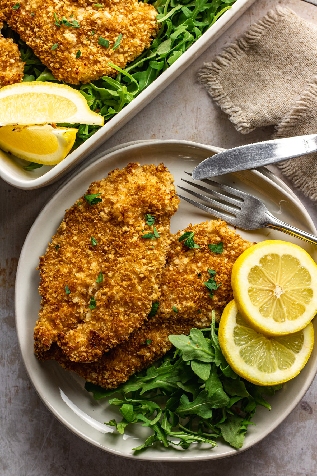 Above view of panko crusted chicken served with fresh lemon