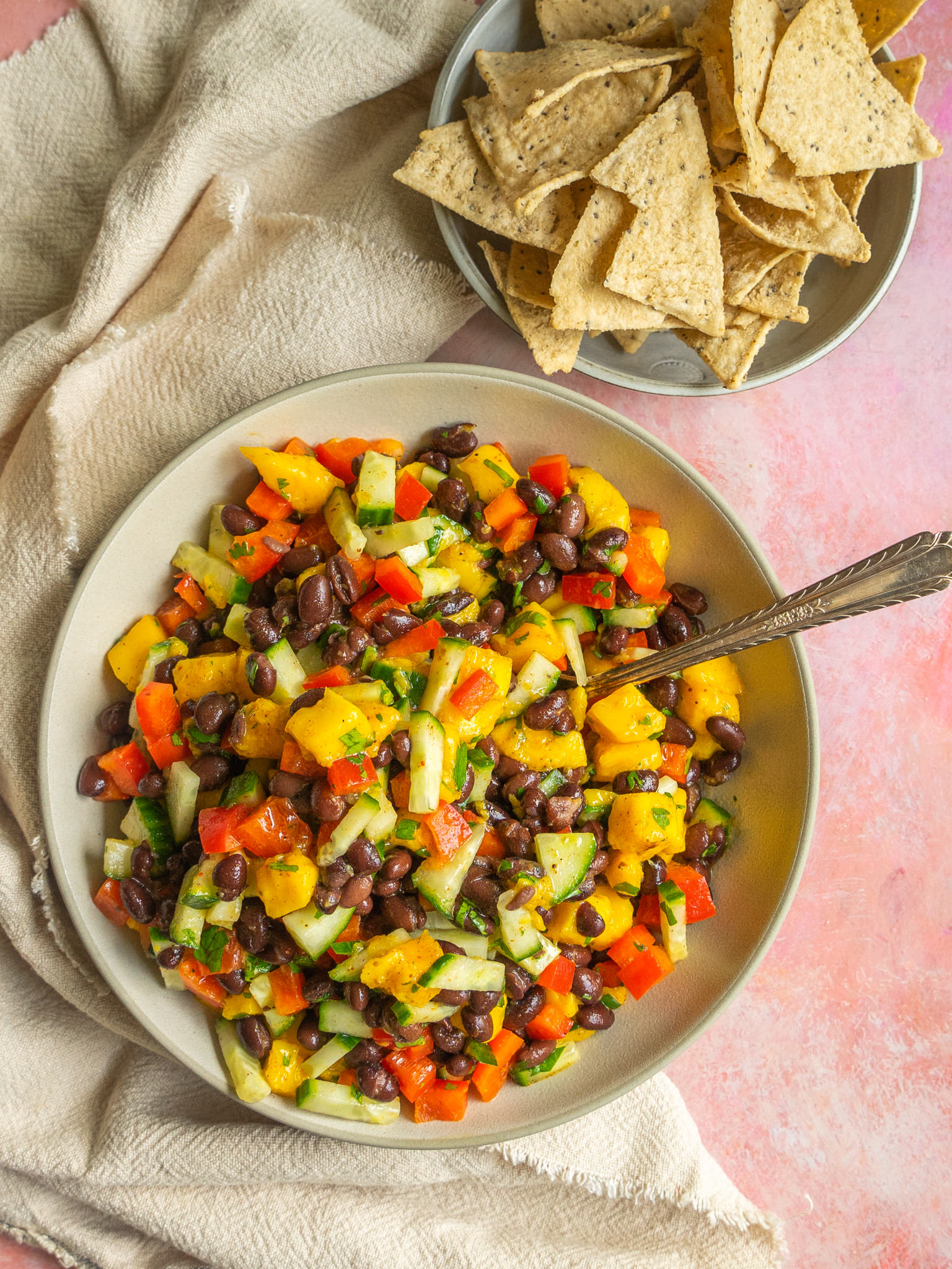 Mango salad recipe in a serving bowl with a serving spoon