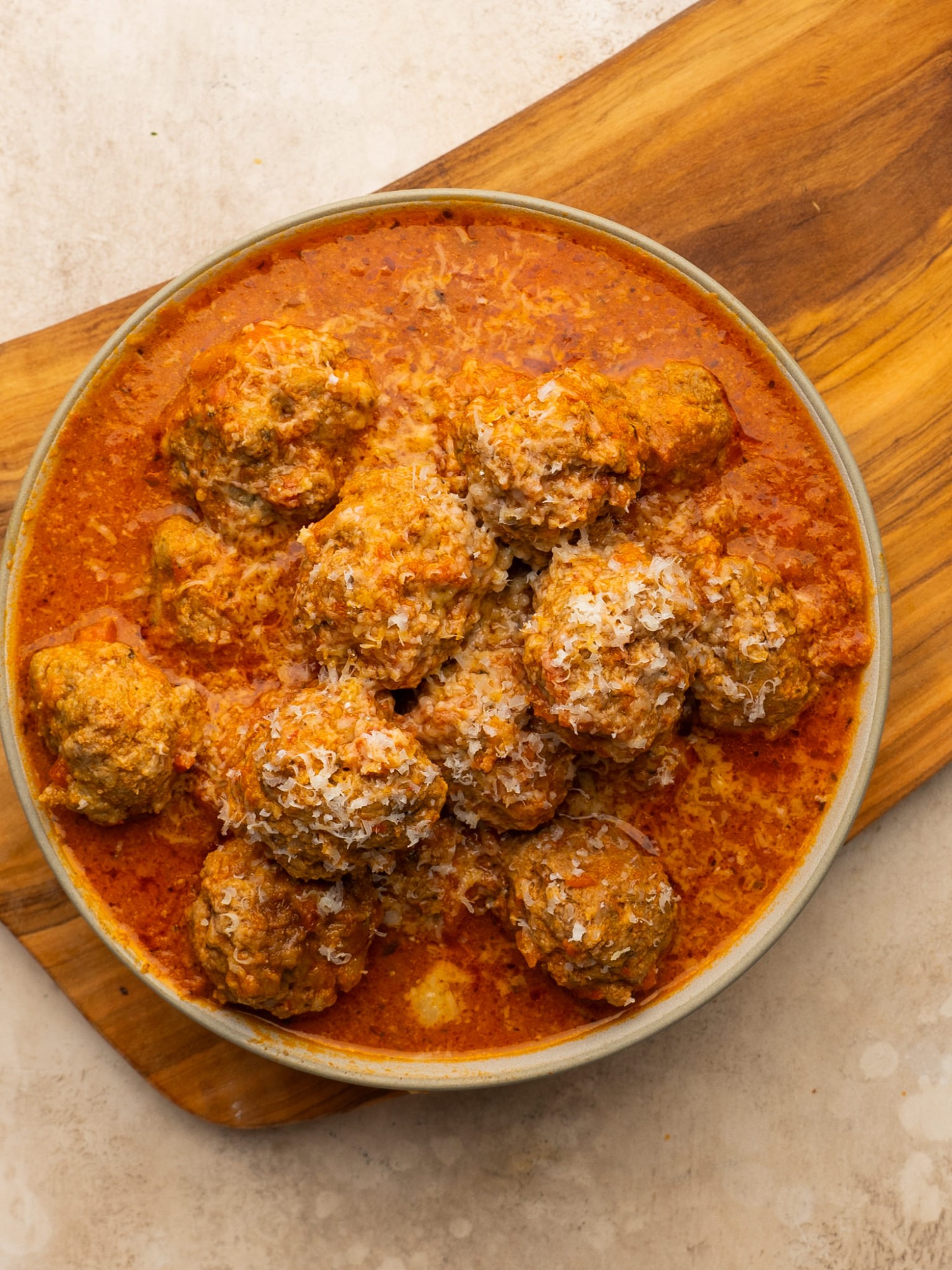 Slow cooker meatballs served with fresh parmesan cheese
