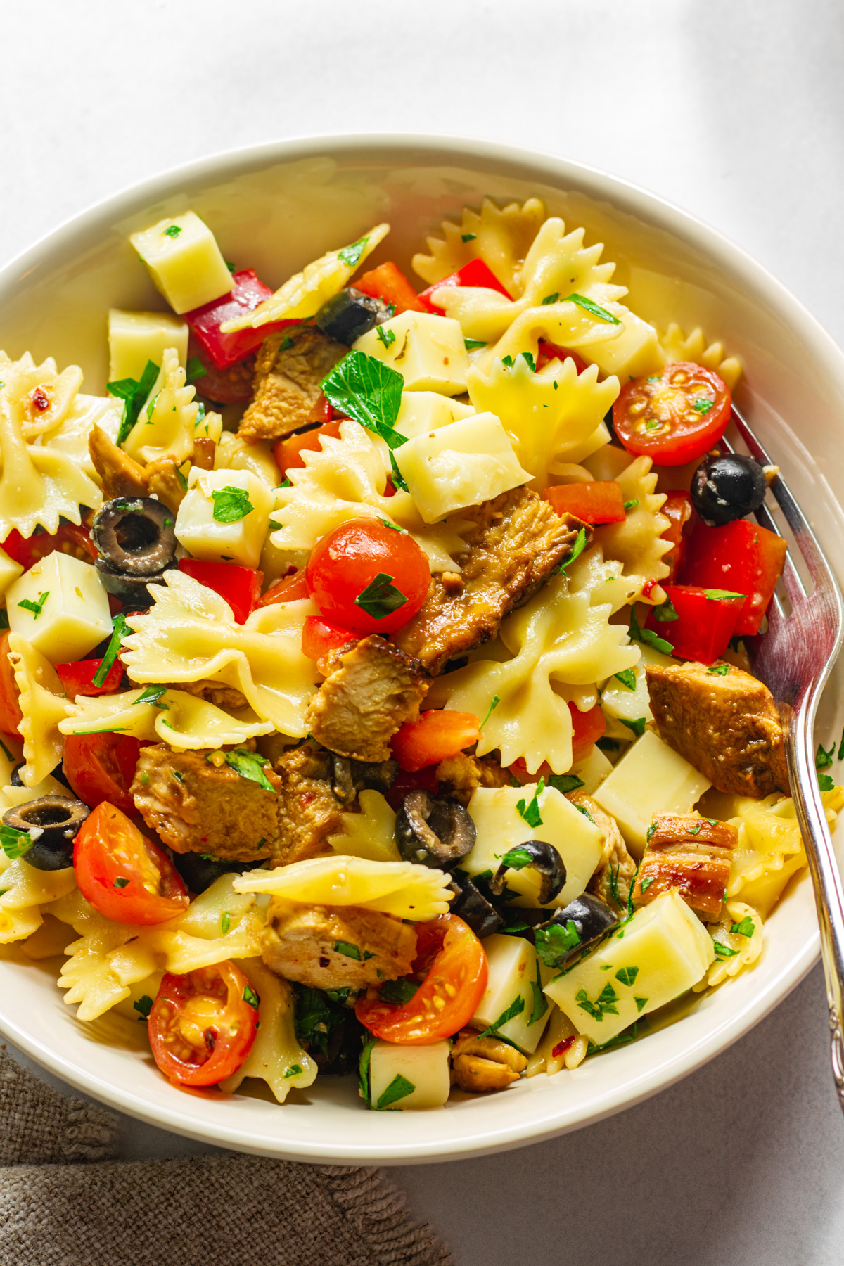 Above view of bow tie pasta salad in a serving bowl