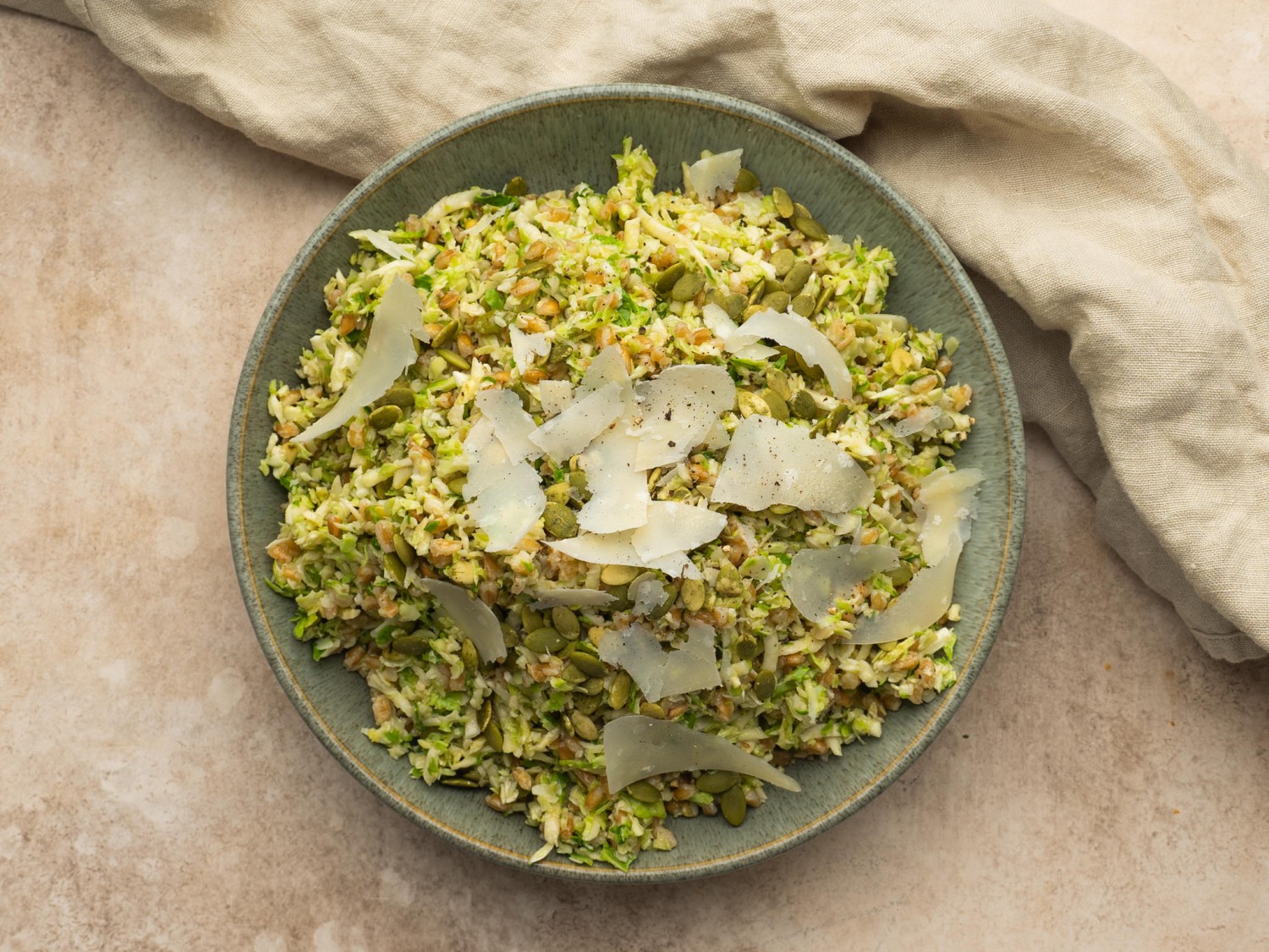 Brussel sprout salad recipe served with shaved parmesan cheese