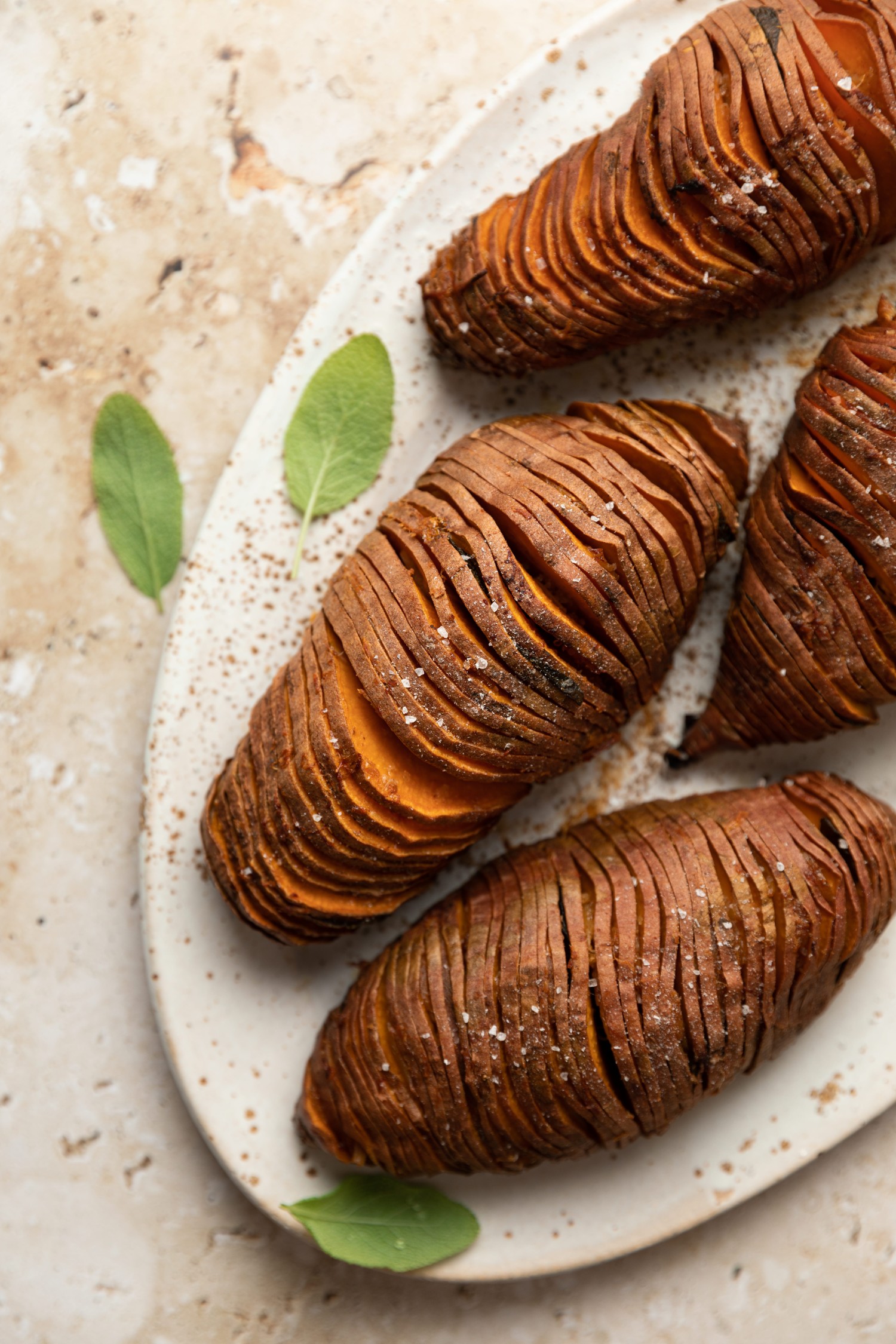 Above view of cooked hasselback sweet potatoes on a serving platter