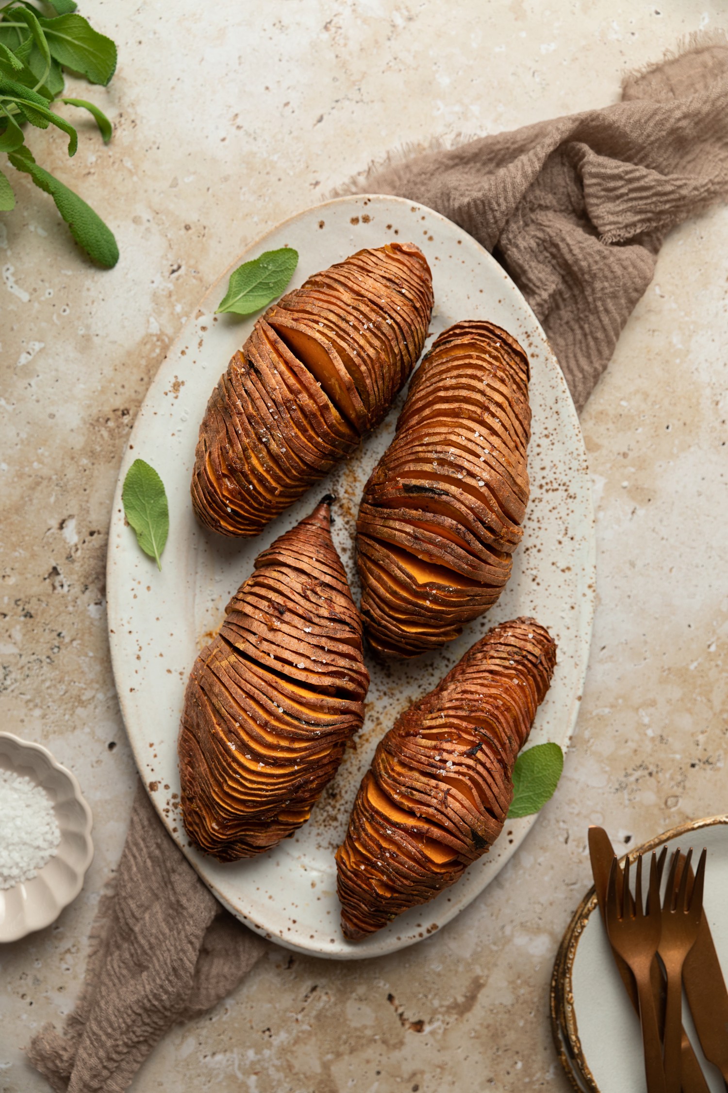 Above view of cooked hasselback sweet potatoes on a serving platter