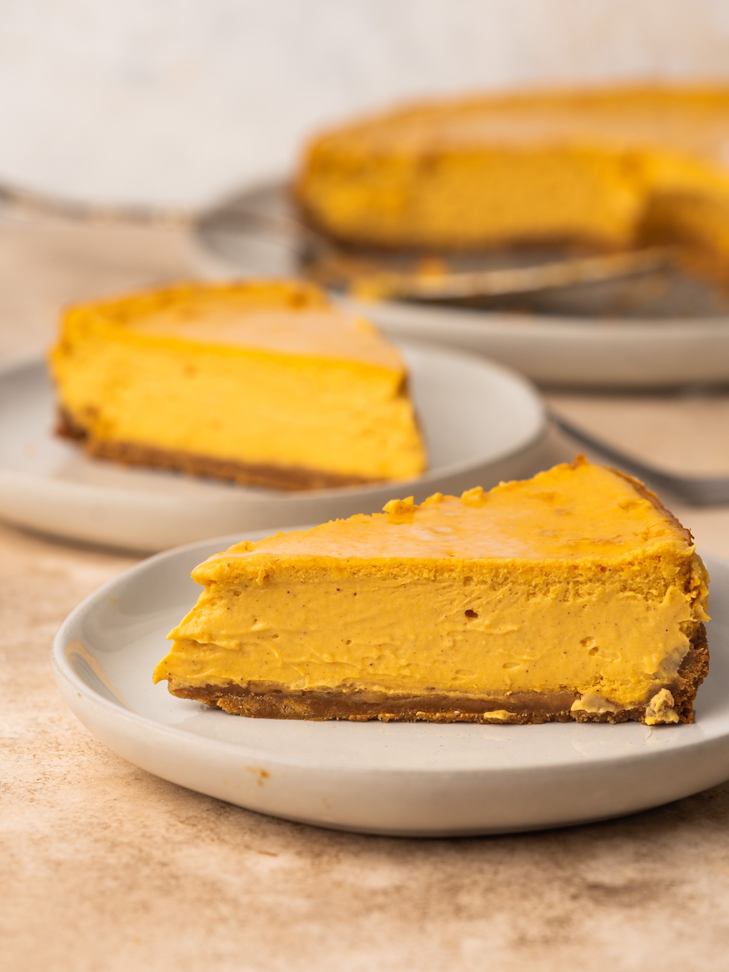 Side view of two slices of a sweet potato cheesecake recipe