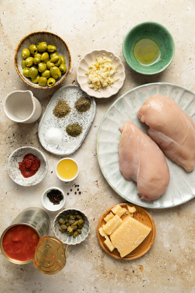 Above view of ingredients for a puttanesca sauce with chicken