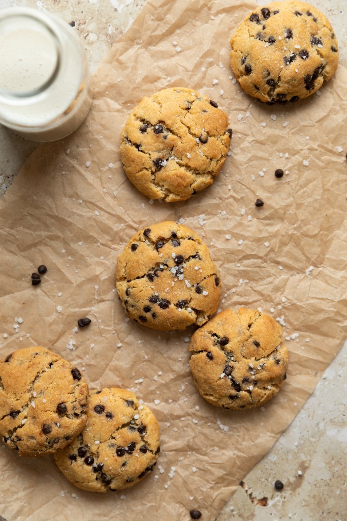 Above view of chocolate chip cookies on a piece of parchment paper from a small batch chocolate chip cookie recipe