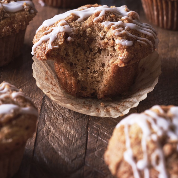 Coffee cake muffins with a bite out of one in the center