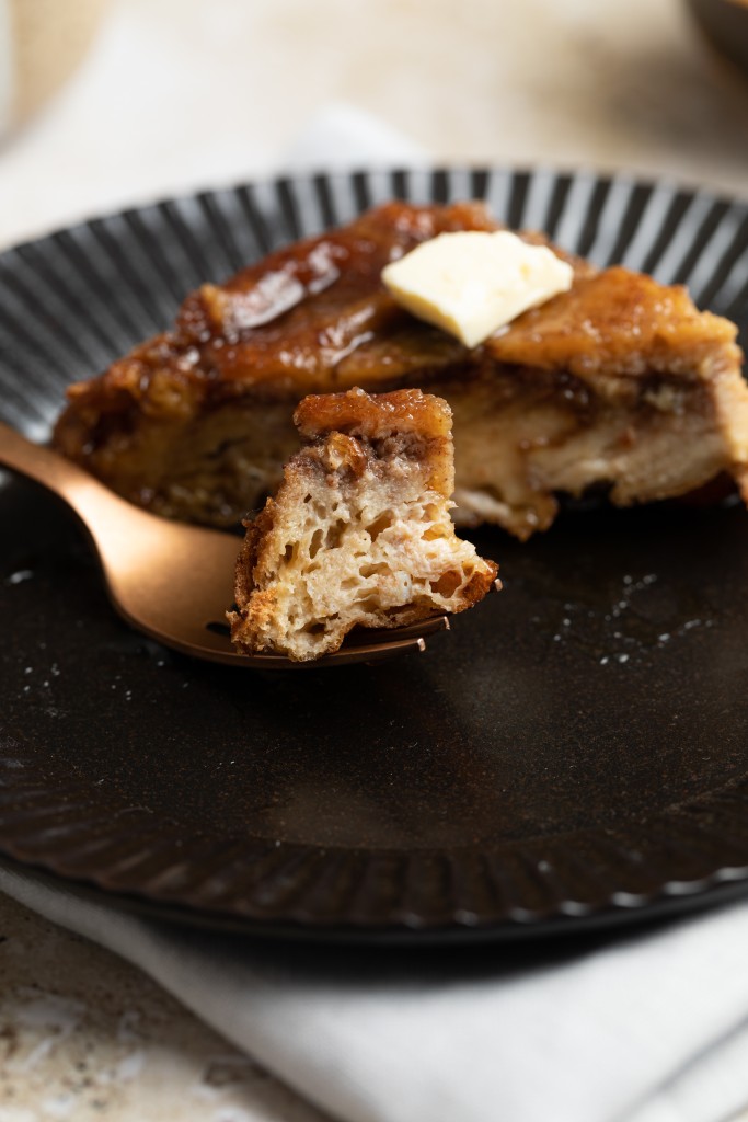 Side view of a slice of overnight french toast casserole with a bite cut off