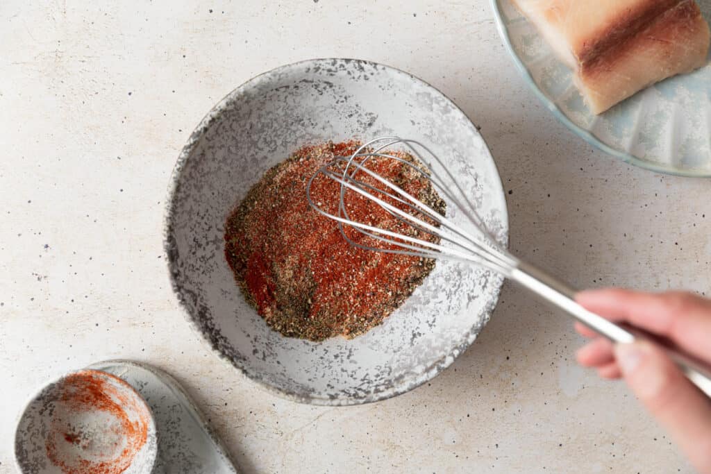 blackened seasoning in a bowl with a whisk in it