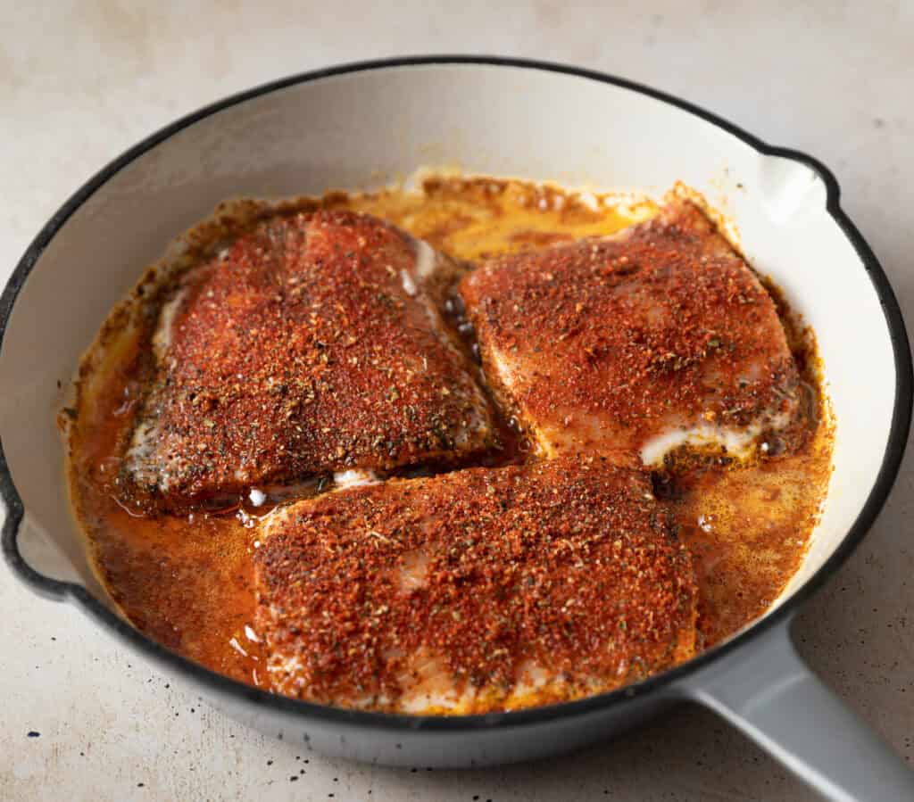 three mahi mahi fillets in a skillet