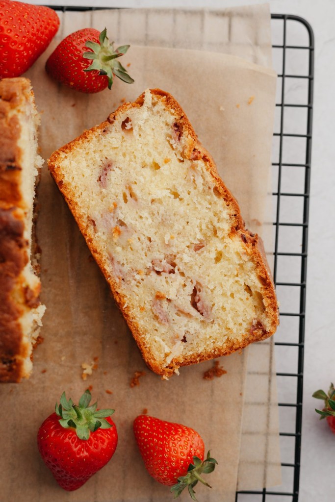 Slice of strawberry pound cake on a cooling rack