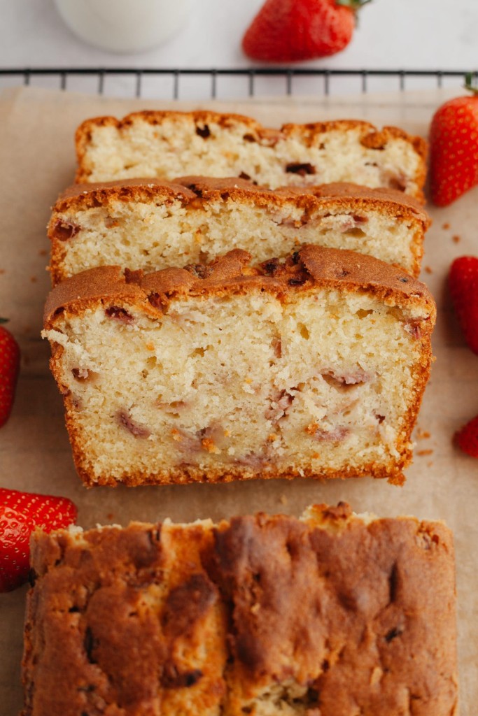 Above view of a strawberry cake recipe with slices cut