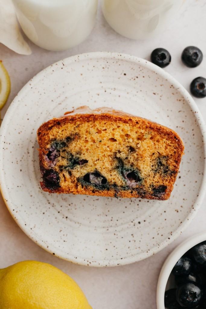 One slice of blueberry lemon bread on a plate.