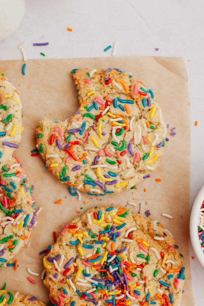 Large sprinkle cookies on a piece of parchment paper