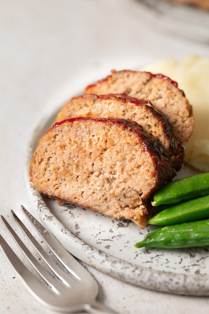 Close up view of sliced air fryer meatloaf on a serving plate