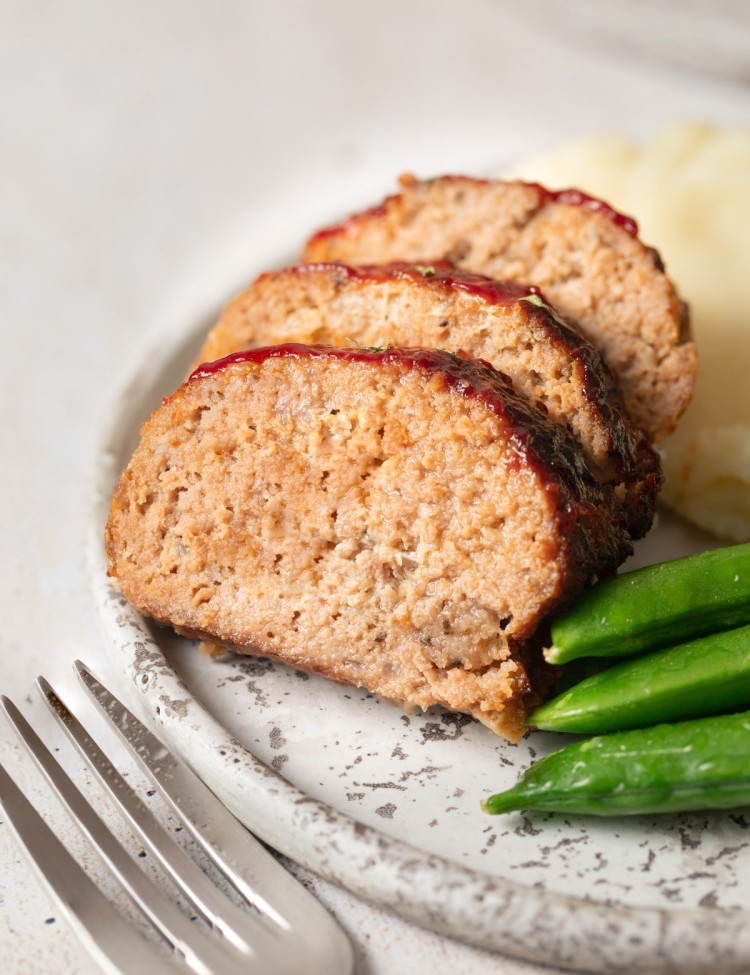 Close up view of sliced air fryer meatloaf on a serving plate