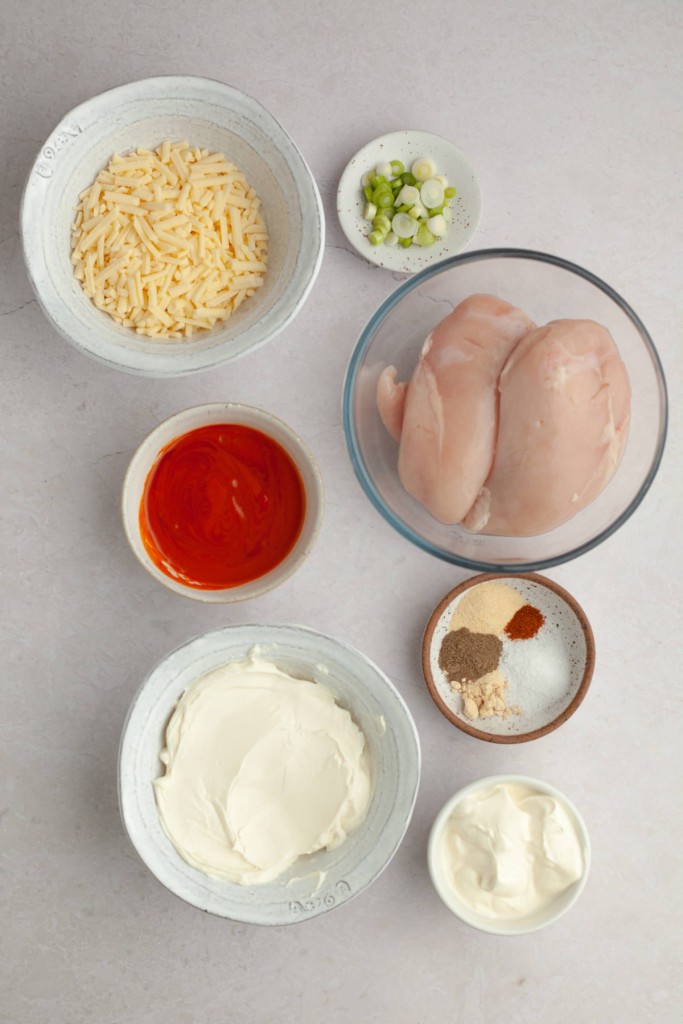 Above view of ingredients for a crockpot buffalo chicken dip