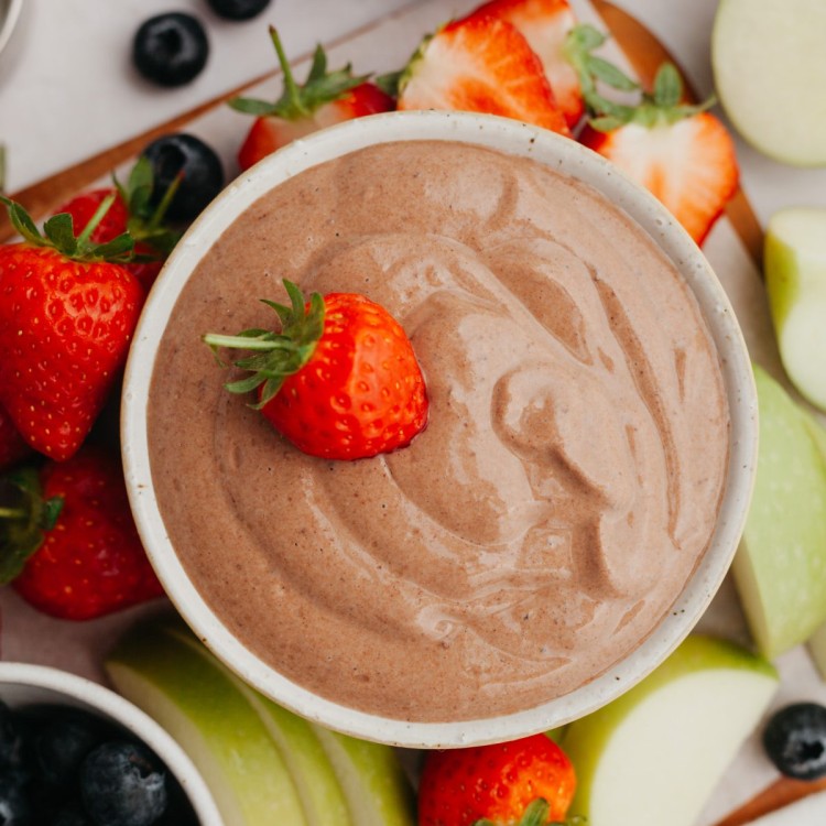 Above view of creamy chocolate dip for fruit served with strawberry