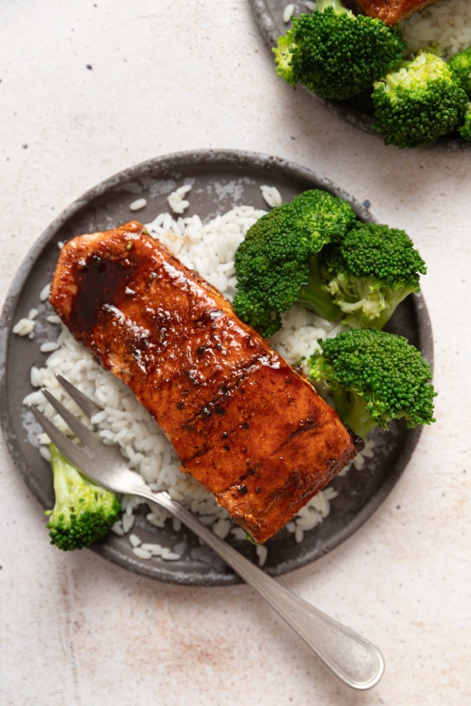 Above view of honey glazed salmon on a plate with white rice and broccoli