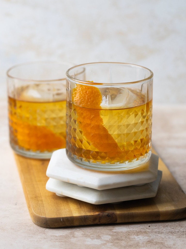 Side view of an old fashioned made with rum in a short cocktail glass