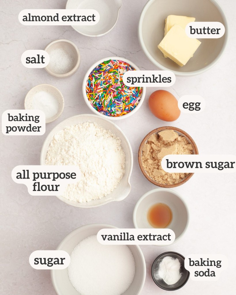 Above view of ingredients for sprinkle cookies with labels on each ingredients