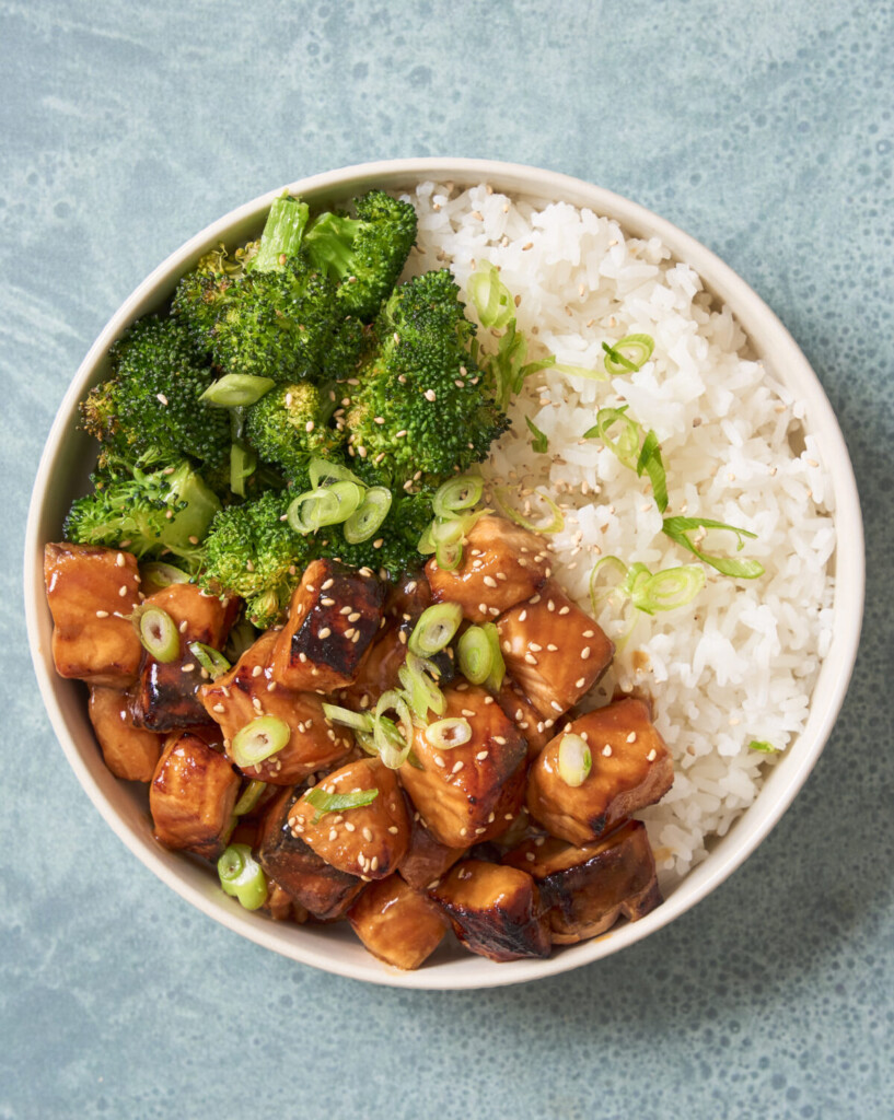 an above view photo of air fryer salmon bites in a bowl with rice and broccoli